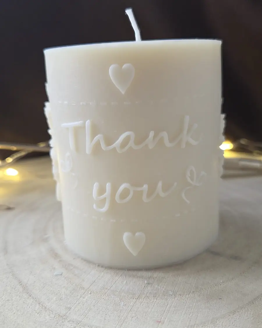 Ivory pillar candle with the words Thank you and two hearts