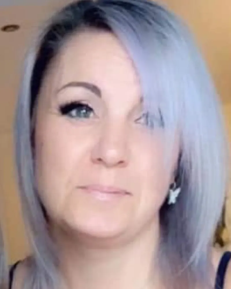Lesley, who makes the candles, with silver-lilac hair and a butterfly earring